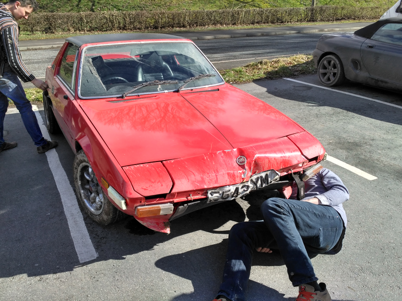 After the crash, the car still untouched. Missing bumper and grille parts stored in the trunk